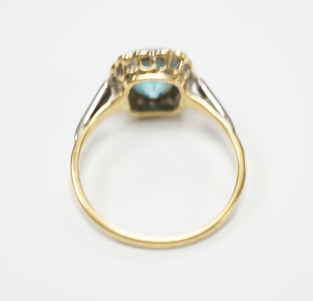 An 18ct and plat, blue zircon and diamond chip cluster set ring, size O, gross weight 3.4 grams.